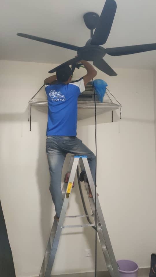 Technician working beside ceiling fan